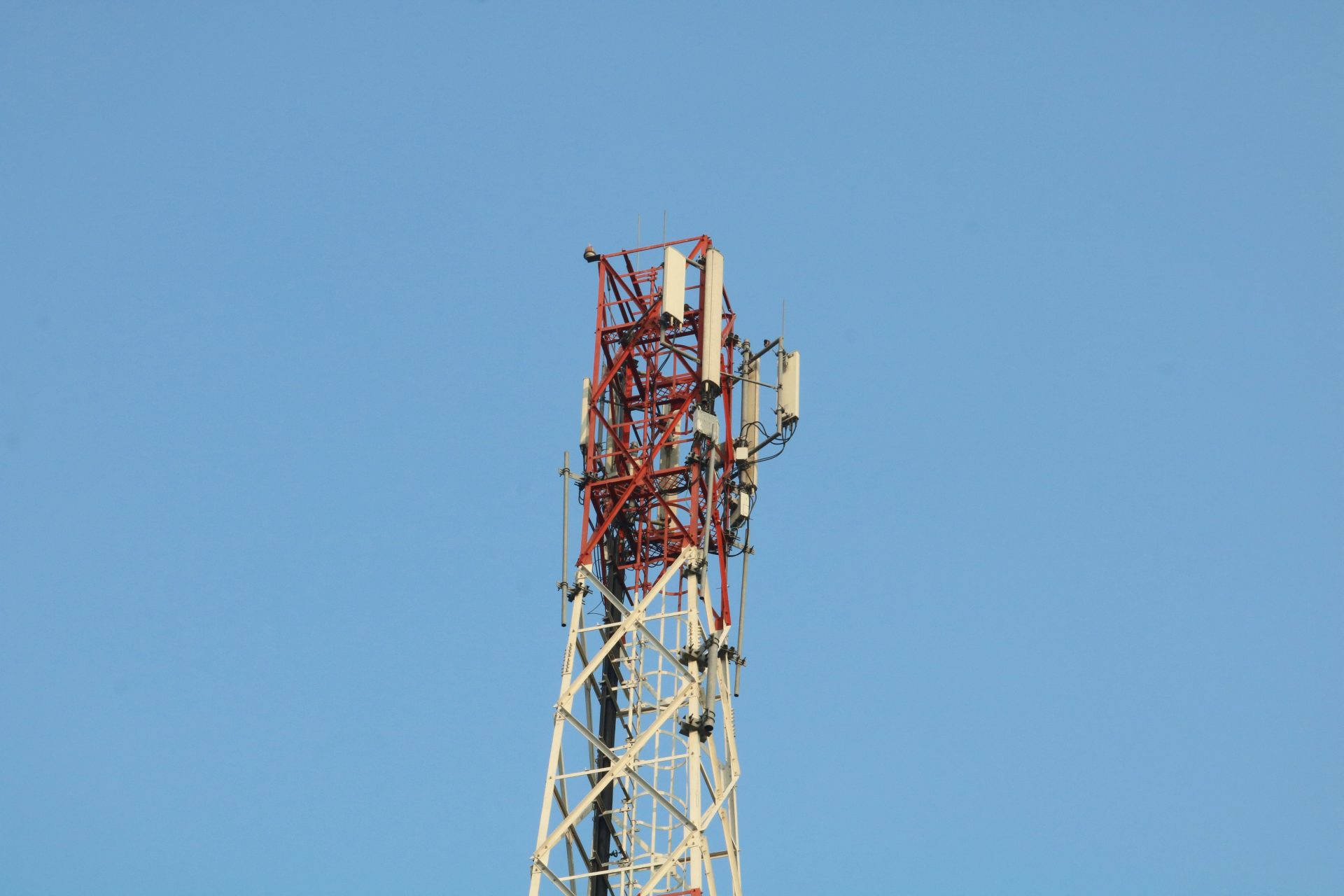 a cell phone tower with a blue sky in the background